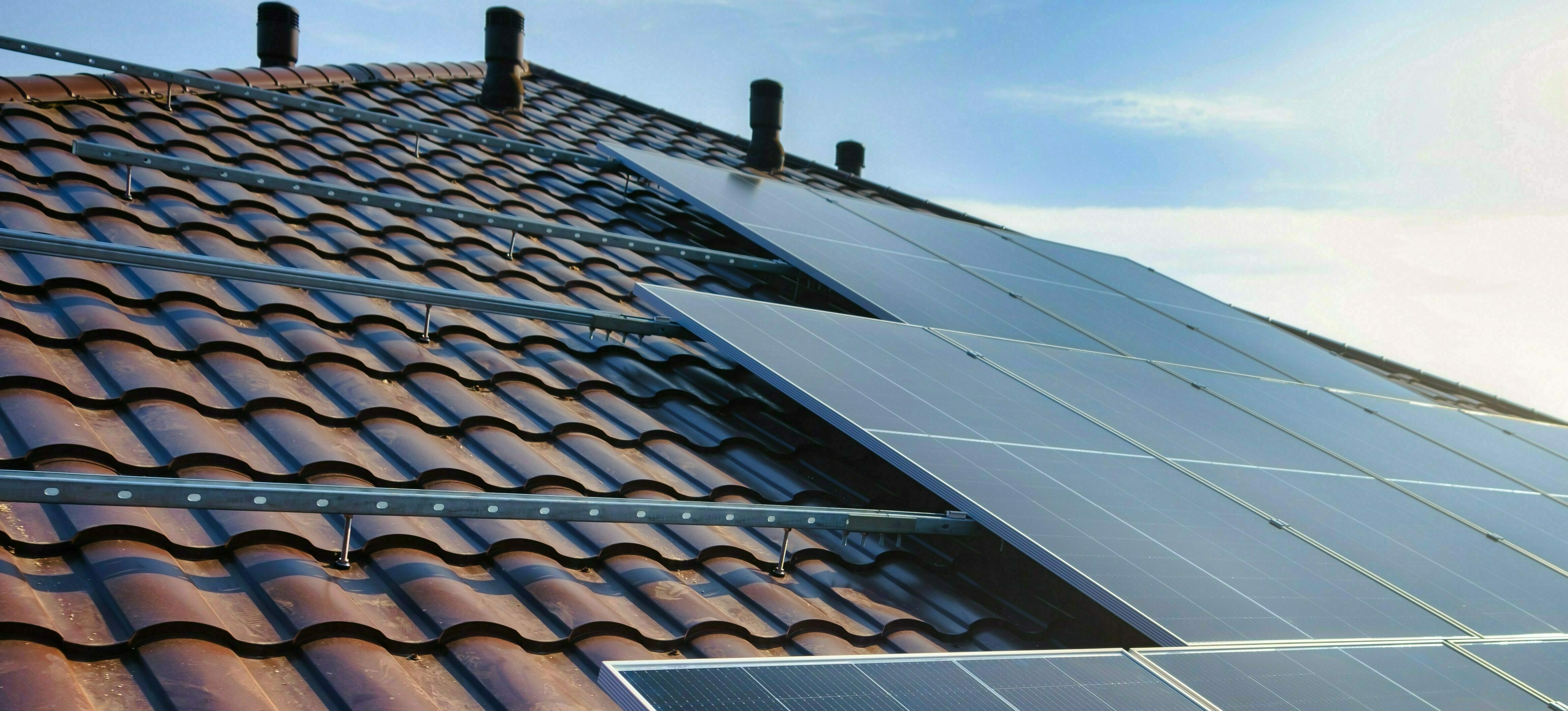 Solar panels attached to roof tiles. Photo
